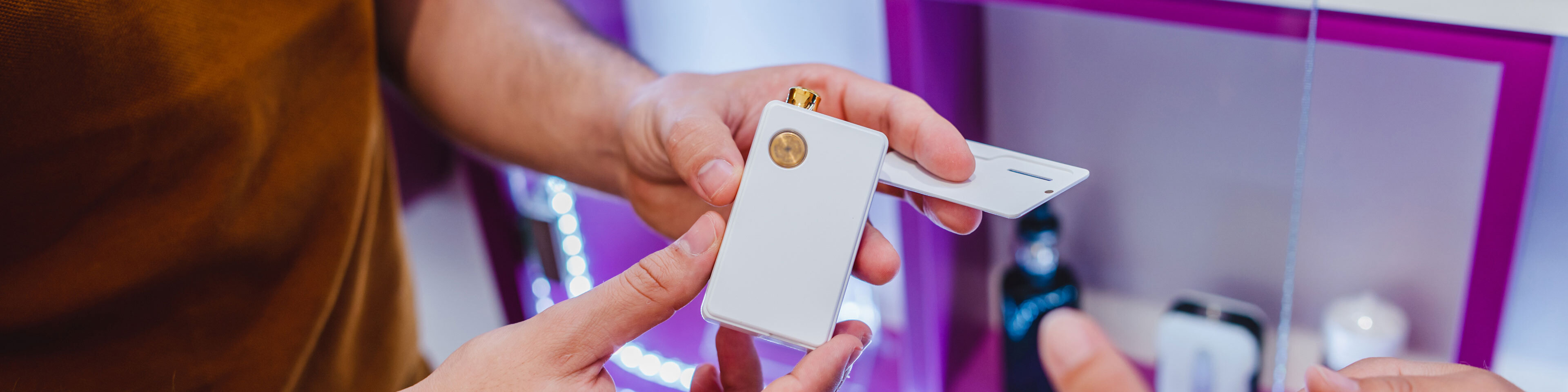 A man's hands holding an electronic cigarette