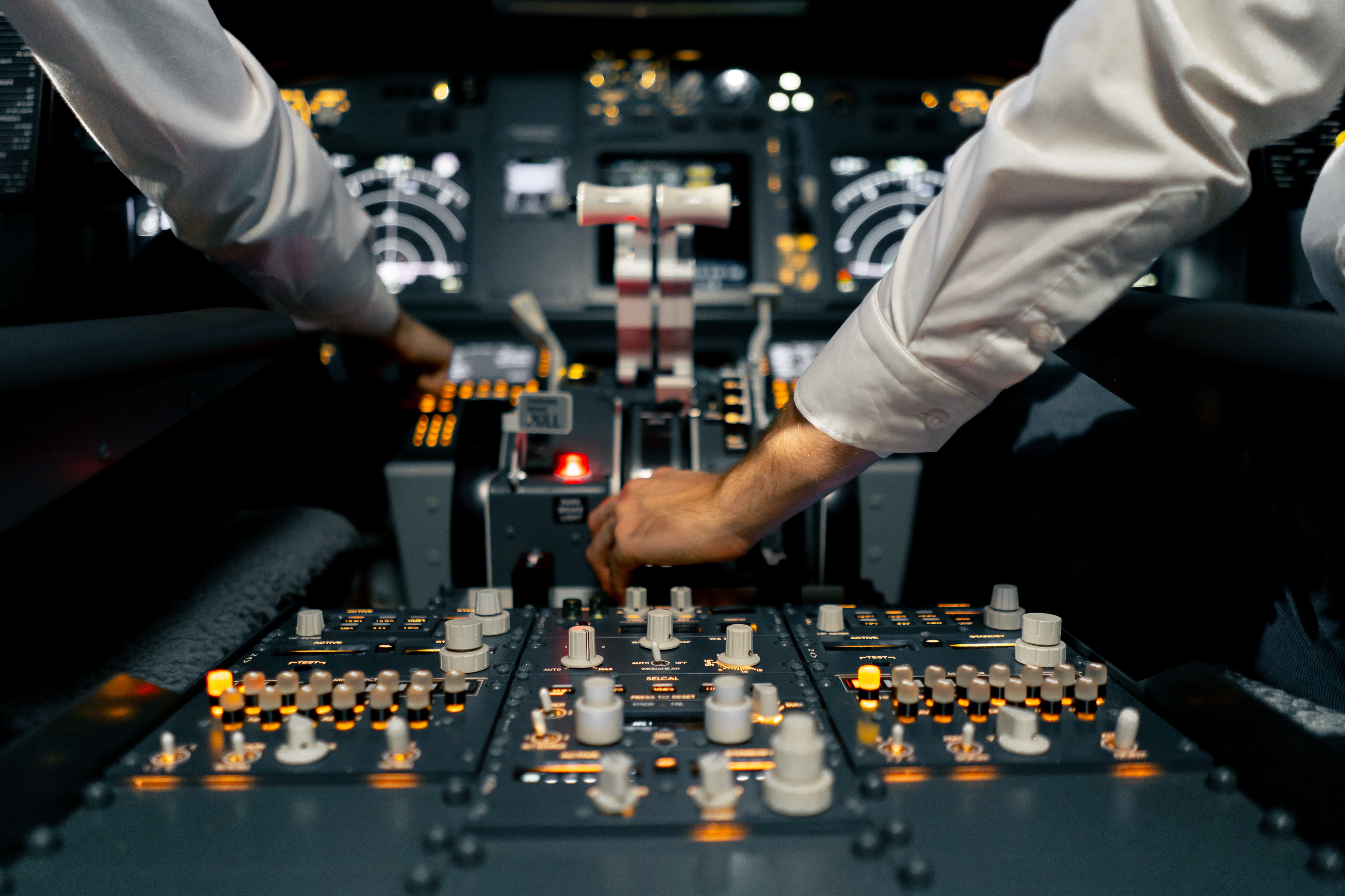 SMS & Bowtie - close-up of the cockpit of a passenger plane with many buttons on the control panel of airplane flight simulator - Expert insights